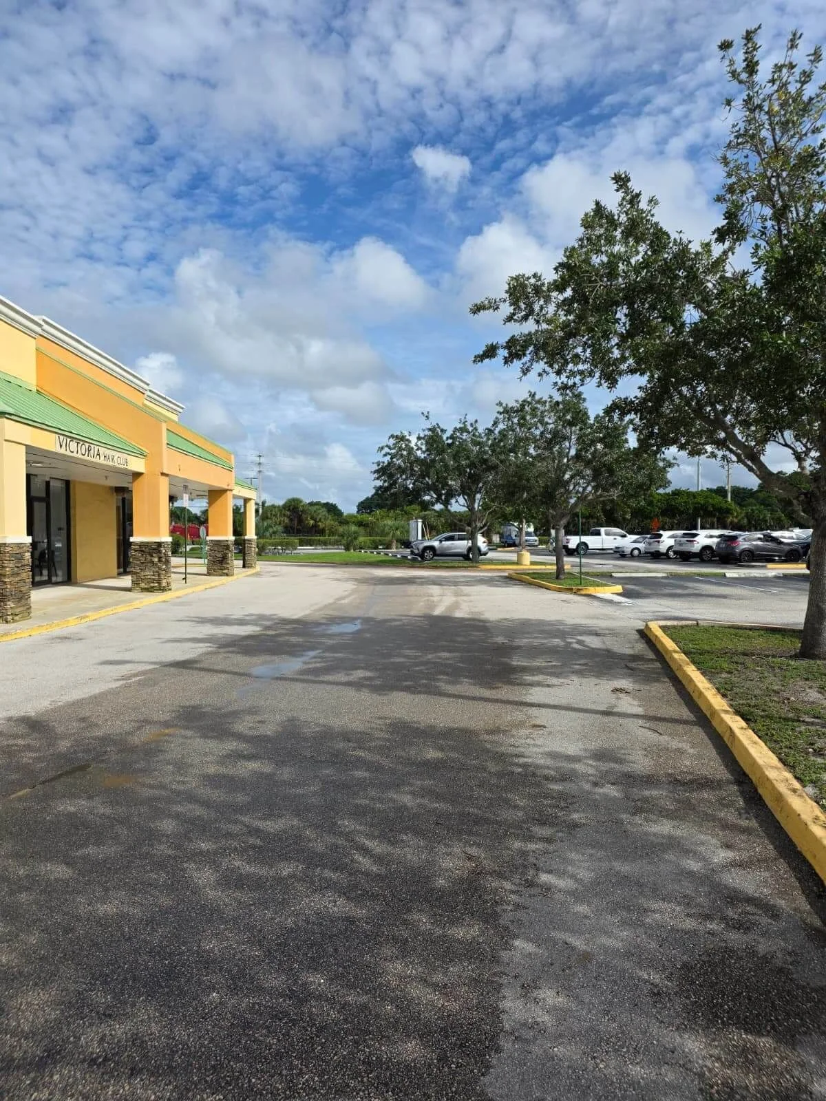 Victoria Hair Club entrance beside the shopping plaza parking area