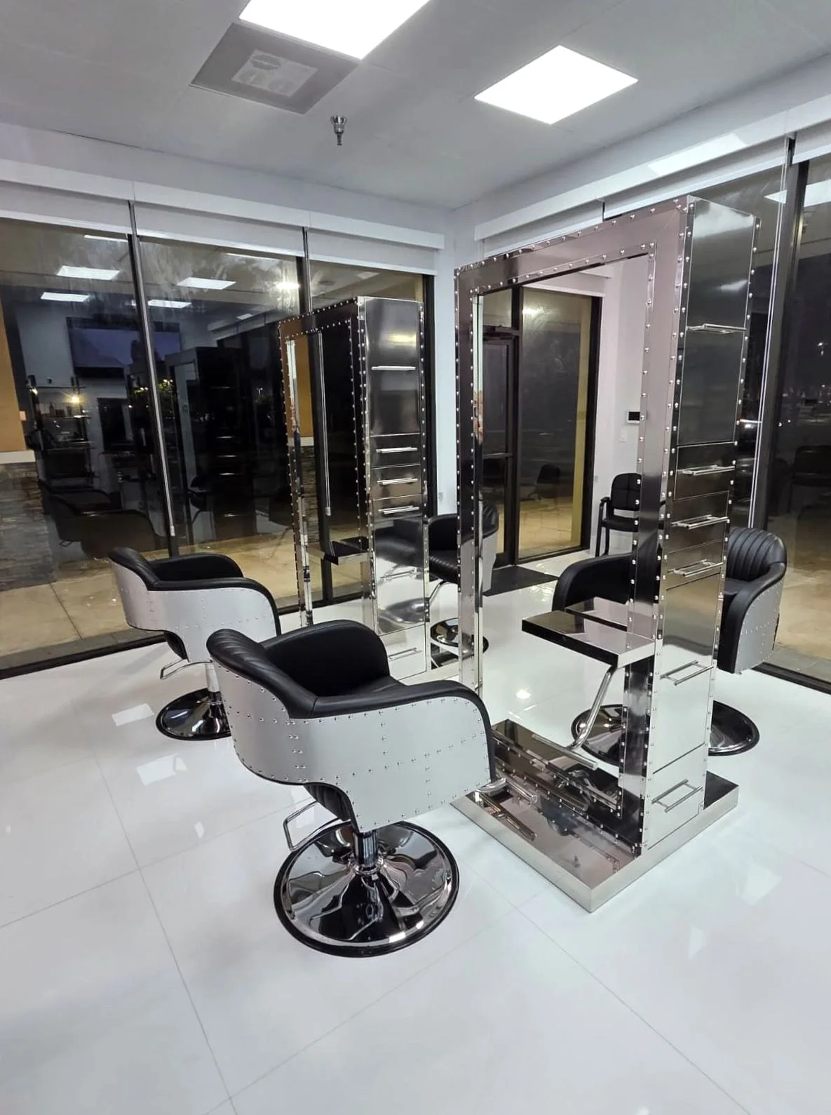 Victoria Hair Club styling stations lit up in the evening