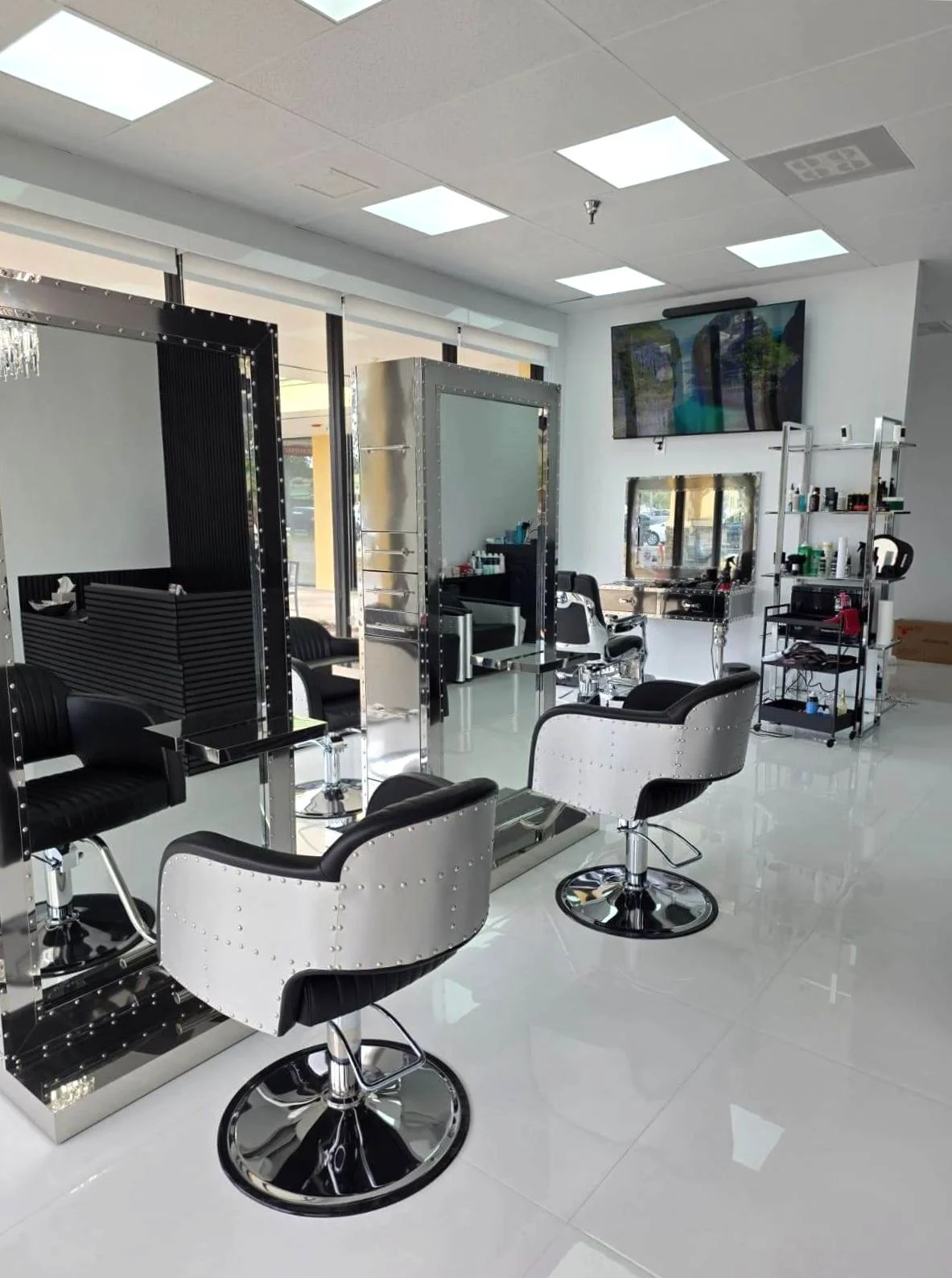 Chrome styling chairs and mirrored stations inside Victoria Hair Club